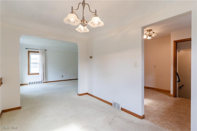1403 Wexford Ave, Parma, OH 44134 - empty room with a chandelier, carpet floors, and arched walkways