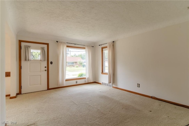 1403 Wexford Ave, Parma, OH 44134 - entrance foyer featuring light carpet and a textured ceiling