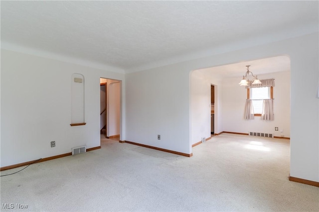 1403 Wexford Ave, Parma, OH 44134 - carpeted empty room with a chandelier and baseboards