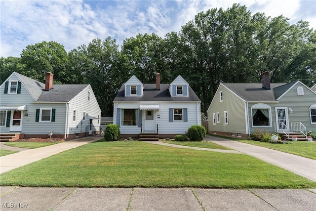 1403 Wexford Ave, Parma, OH 44134 - cape cod-style house featuring entry steps, a front lawn, and a chimney