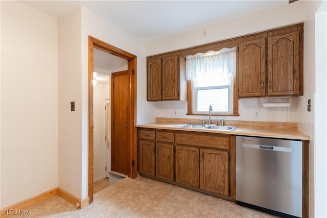 1403 Wexford Ave, Parma, OH 44134 - kitchen featuring dishwasher, brown cabinets, light countertops, and tasteful backsplash