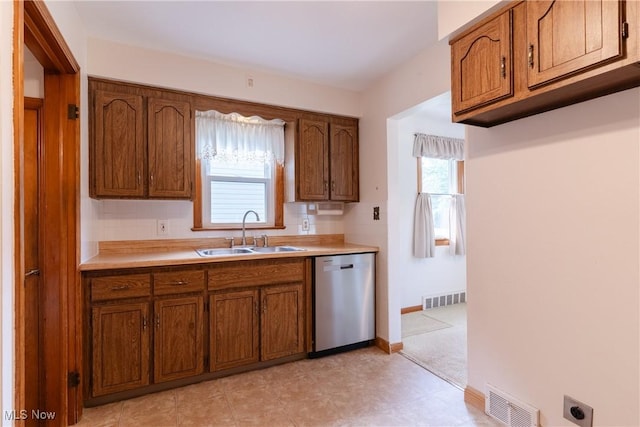 1403 Wexford Ave, Parma, OH 44134 - kitchen featuring dishwasher, brown cabinetry, and light countertops