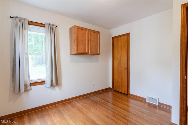 1403 Wexford Ave, Parma, OH 44134 - empty room with light wood-style floors and baseboards