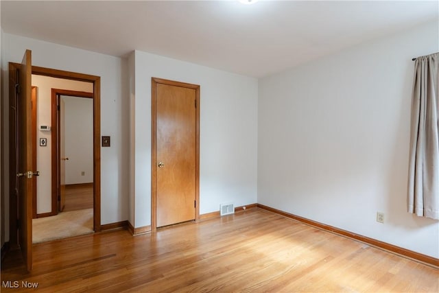 1403 Wexford Ave, Parma, OH 44134 - unfurnished bedroom with light wood finished floors and a closet