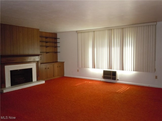 373 E 232nd St, Euclid, OH 44123 - unfurnished living room featuring a fireplace with raised hearth, wood walls, and carpet floors