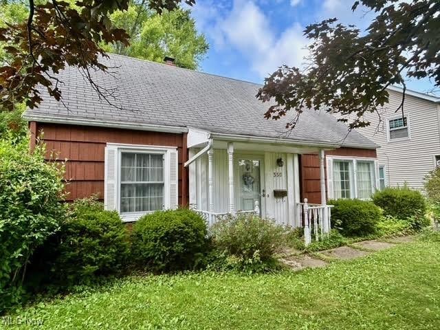 330 Inwood Blvd, Avon Lake, OH 44012 - view of front facade with roof with shingles, a chimney, and a front yard