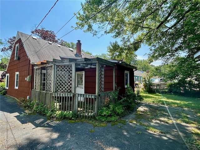 330 Inwood Blvd, Avon Lake, OH 44012 - view of side of home featuring a chimney and a shingled roof