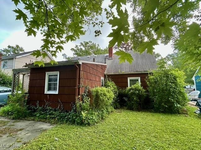330 Inwood Blvd, Avon Lake, OH 44012 - view of property exterior featuring a lawn and a chimney