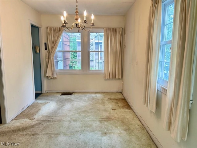 330 Inwood Blvd, Avon Lake, OH 44012 - unfurnished dining area with a chandelier and carpet floors