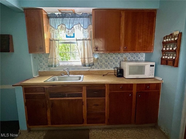 330 Inwood Blvd, Avon Lake, OH 44012 - kitchen featuring white microwave, light countertops, and brown cabinets