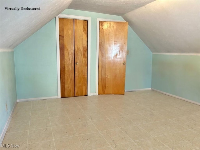 330 Inwood Blvd, Avon Lake, OH 44012 - bonus room featuring vaulted ceiling, a textured ceiling, and tile patterned floors