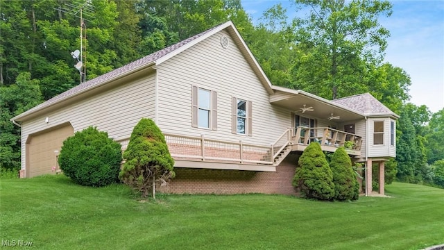 4101 Oak Ridge Ln, Cambridge, OH 43725 - back of property featuring a ceiling fan, a garage, a yard, and a wooden deck