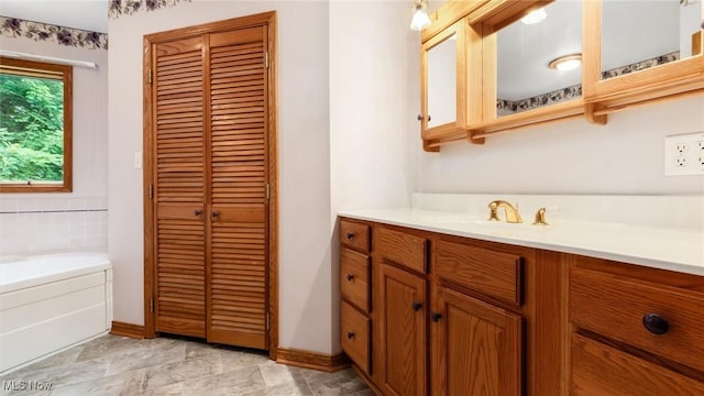4101 Oak Ridge Ln, Cambridge, OH 43725 - bathroom with a closet, vanity, and a garden tub