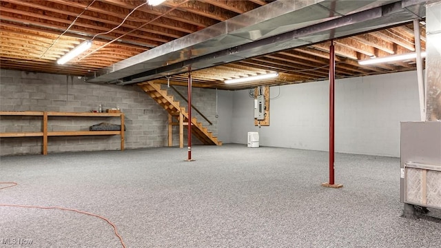 4101 Oak Ridge Ln, Cambridge, OH 43725 - unfinished basement with electric panel, stairway, and concrete block wall