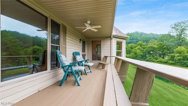 4101 Oak Ridge Ln, Cambridge, OH 43725 - deck featuring a ceiling fan and a wooded view