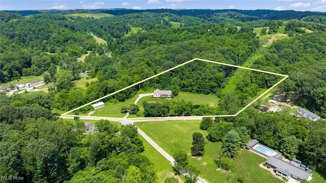 4101 Oak Ridge Ln, Cambridge, OH 43725 - aerial view of property and surrounding area featuring a heavily wooded area and property parcel outlined