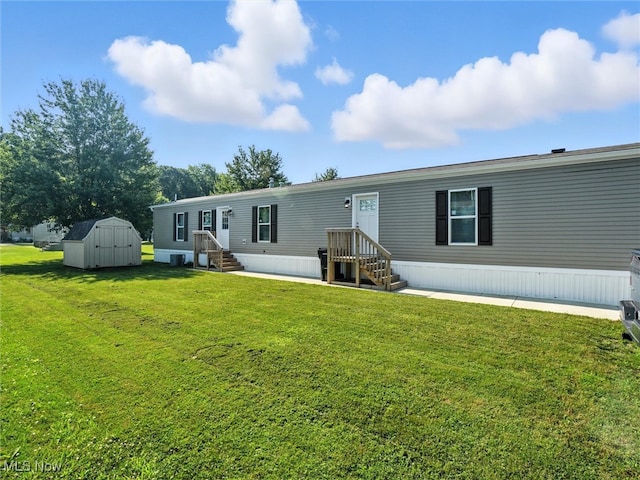 187 Garfield Ln, Jefferson, OH 44047 - rear view of property featuring a storage shed, a lawn, and entry steps