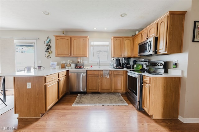 32 Par Three Dr, Follansbee, WV 26037 - kitchen with stainless steel appliances, a peninsula, light wood-style flooring, light countertops, and recessed lighting