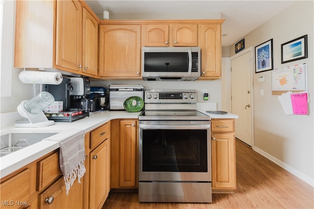 32 Par Three Dr, Follansbee, WV 26037 - kitchen with appliances with stainless steel finishes, light wood-style flooring, and light countertops