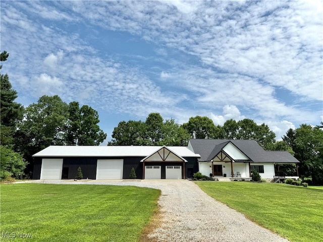 2710 E Hutton Rd, Wooster, OH 44691 - view of front facade with a front lawn, a garage, and driveway