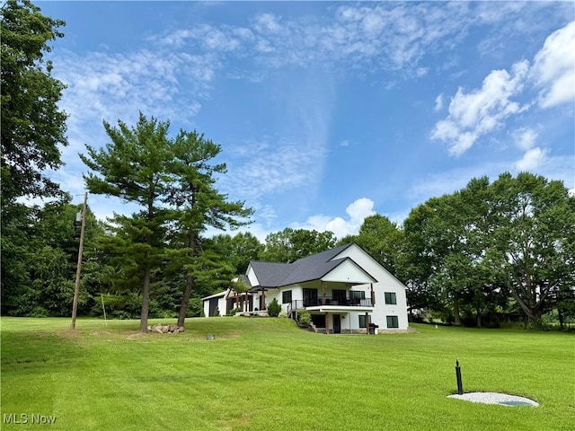 2710 E Hutton Rd, Wooster, OH 44691 - rear view of house with a balcony, a lawn, and a garage