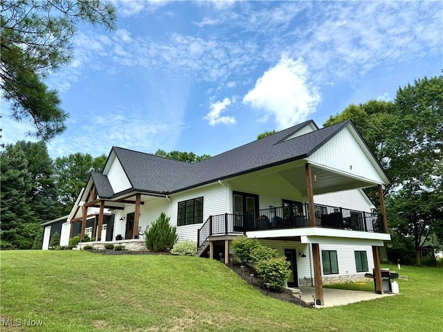 2710 E Hutton Rd, Wooster, OH 44691 - rear view of house featuring a yard, a patio, and a shingled roof