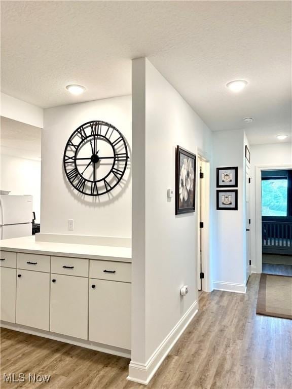 2710 E Hutton Rd, Wooster, OH 44691 - corridor featuring light wood-style flooring and a textured ceiling