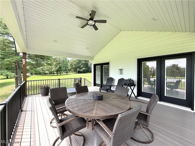 2710 E Hutton Rd, Wooster, OH 44691 - wooden deck with outdoor dining area, french doors, a lawn, and a ceiling fan