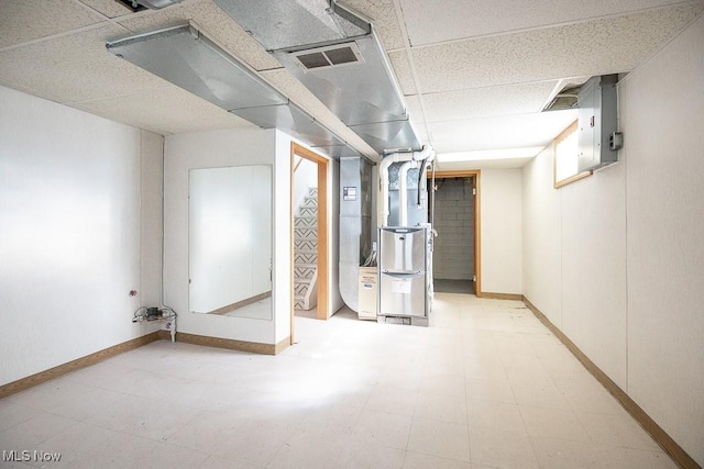 4435 W 58th St, Cleveland, OH 44144 - finished below grade area with tile patterned floors, heating unit, and a drop ceiling