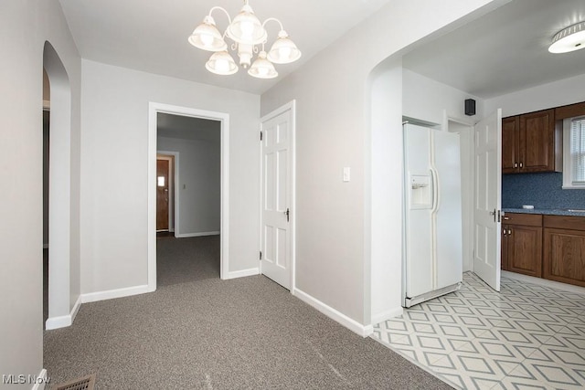 4435 W 58th St, Cleveland, OH 44144 - hallway with arched walkways and a chandelier