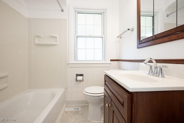 4435 W 58th St, Cleveland, OH 44144 - bathroom featuring vanity, plenty of natural light, tile walls, tile patterned floors, and washtub / shower combination