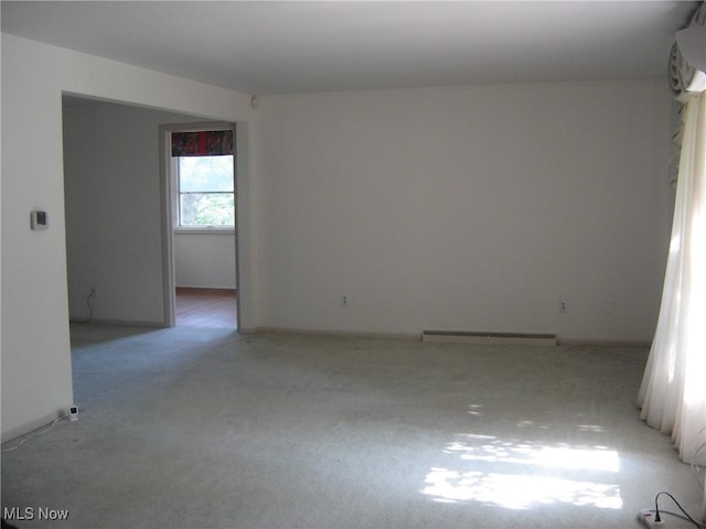 1275 NW Janet Ave, North Canton, OH 44720 - spare room with light carpet and a baseboard radiator