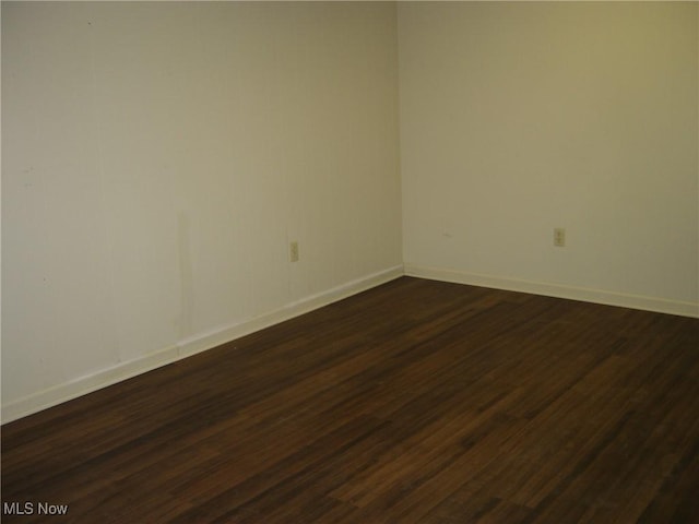 1275 NW Janet Ave, North Canton, OH 44720 - empty room with dark wood-style flooring and baseboards