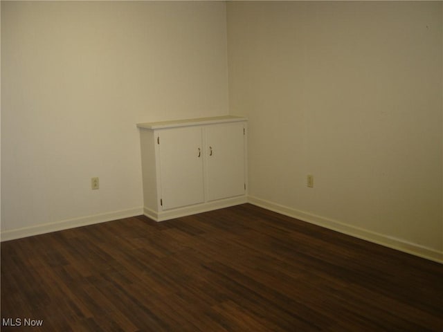 1275 NW Janet Ave, North Canton, OH 44720 - unfurnished room featuring dark wood-style flooring and baseboards