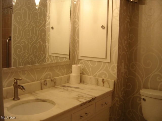 1275 NW Janet Ave, North Canton, OH 44720 - bathroom with vanity and wallpapered walls