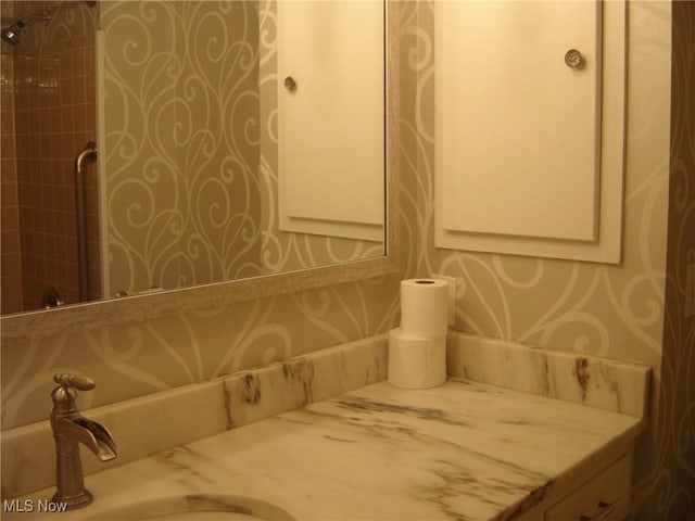 1275 NW Janet Ave, North Canton, OH 44720 - full bath with wallpapered walls, vanity, and a tile shower
