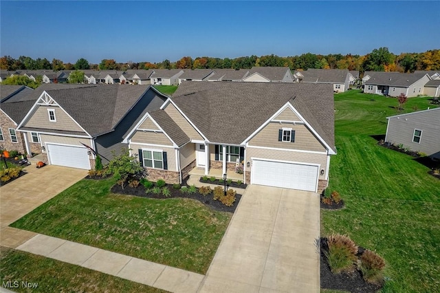 34674 N Legends Way, Grafton, OH 44044 - craftsman-style house featuring stone siding, driveway, a residential view, and a front lawn