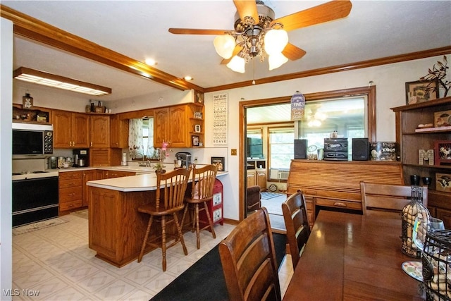1292 Cinder Rd SE, Bergholz, OH 43908 - kitchen featuring range with electric cooktop, stainless steel microwave, open shelves, brown cabinetry, and a peninsula