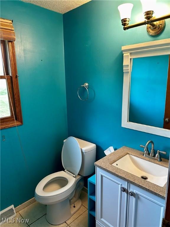 832 Meese Rd NE, Louisville, OH 44641 - half bath with vanity, tile patterned floors, and a textured ceiling