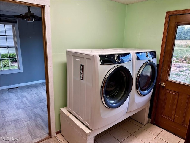 832 Meese Rd NE, Louisville, OH 44641 - washroom featuring washing machine and dryer, healthy amount of natural light, light tile patterned floors, and a ceiling fan