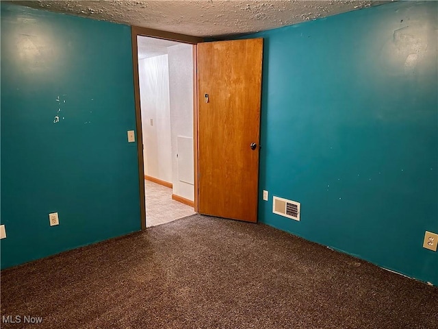 832 Meese Rd NE, Louisville, OH 44641 - carpeted empty room with a textured ceiling