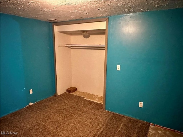 832 Meese Rd NE, Louisville, OH 44641 - unfurnished bedroom with a textured ceiling, carpet floors, and a closet