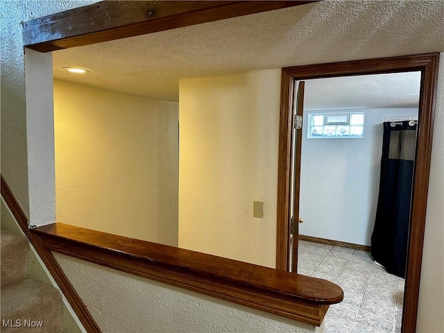 832 Meese Rd NE, Louisville, OH 44641 - corridor featuring a textured wall and light tile patterned floors