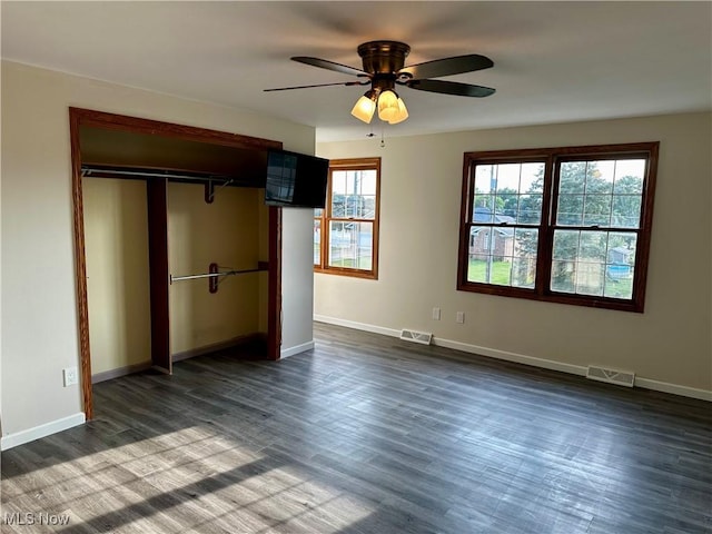 832 Meese Rd NE, Louisville, OH 44641 - unfurnished bedroom featuring dark wood-type flooring, a closet, and a ceiling fan