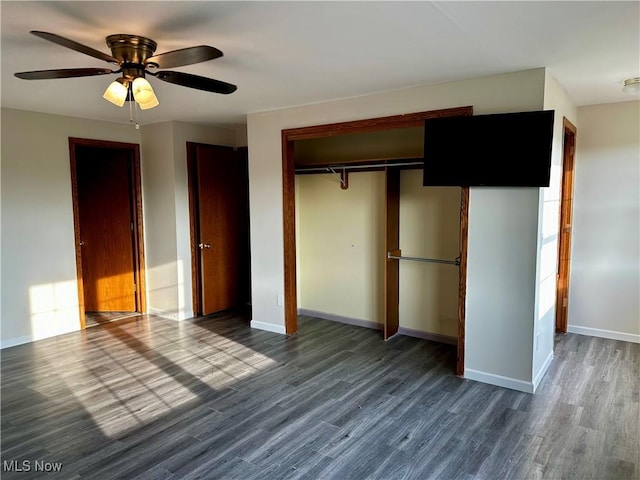 832 Meese Rd NE, Louisville, OH 44641 - unfurnished bedroom with dark wood-style floors, a closet, and a ceiling fan
