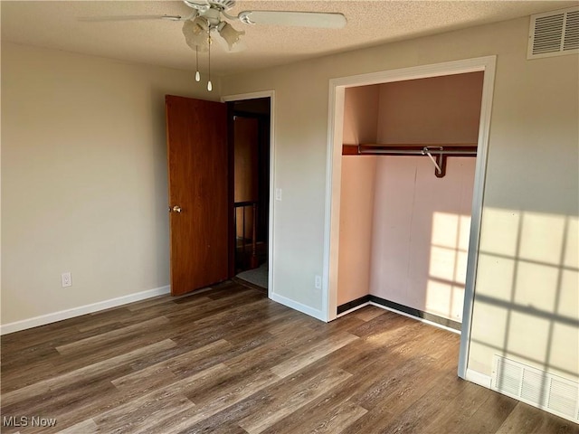 832 Meese Rd NE, Louisville, OH 44641 - unfurnished bedroom featuring a closet, dark wood-style flooring, and a ceiling fan