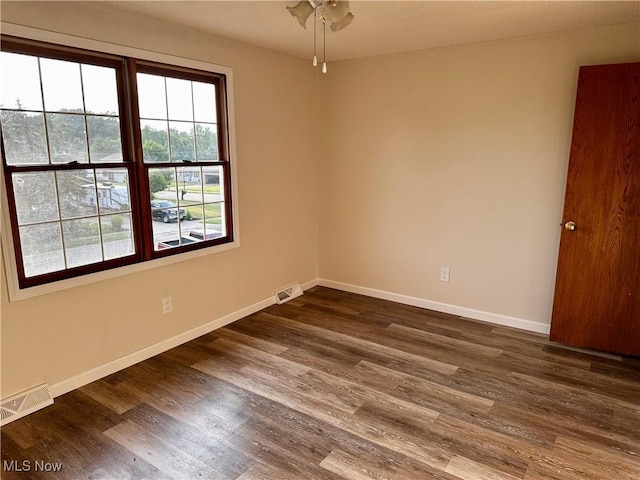 832 Meese Rd NE, Louisville, OH 44641 - spare room with dark wood-style floors and a ceiling fan