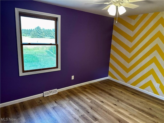 832 Meese Rd NE, Louisville, OH 44641 - unfurnished room featuring wallpapered walls, a ceiling fan, and wood finished floors