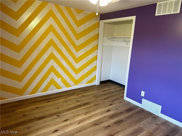 832 Meese Rd NE, Louisville, OH 44641 - unfurnished bedroom with dark wood-type flooring and a closet