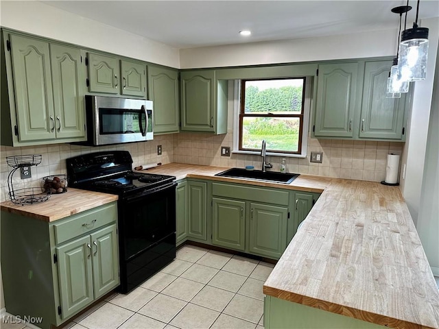 832 Meese Rd NE, Louisville, OH 44641 - kitchen with green cabinets, black range with electric stovetop, stainless steel microwave, and backsplash
